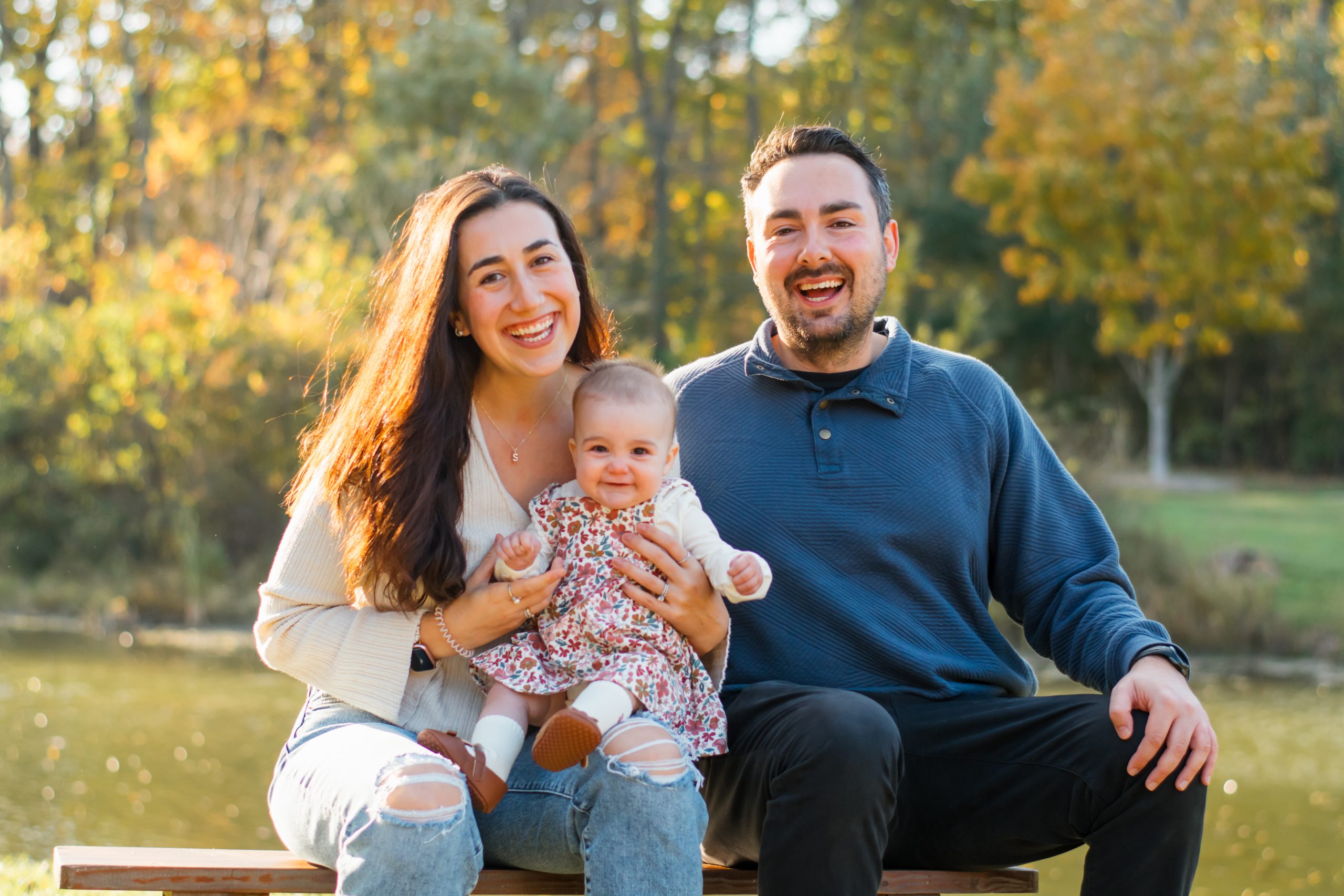 Two parents and a baby in nature.