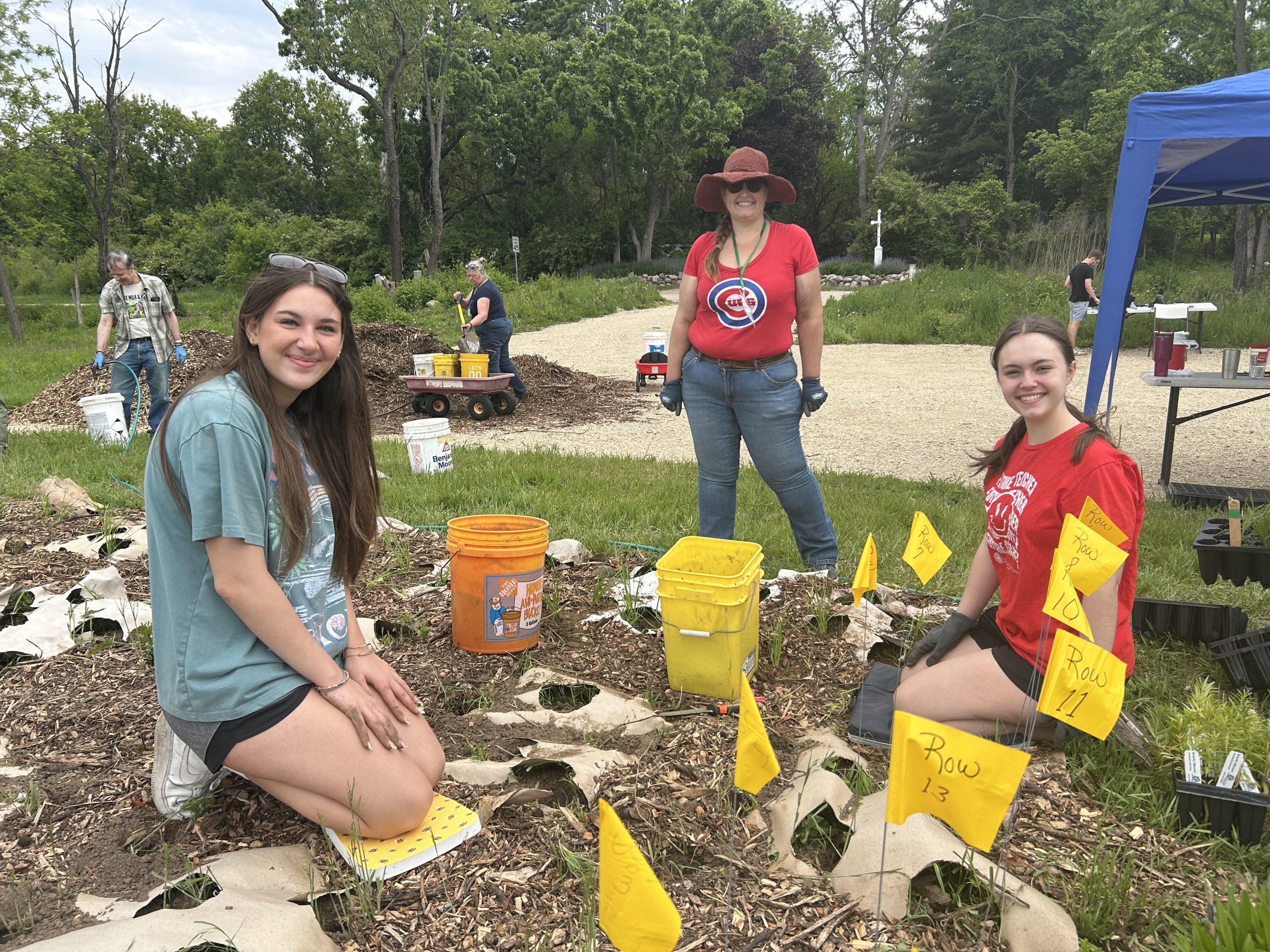People planting a pollinator garden at Thompson Road Preserve in Bull Valley IL
