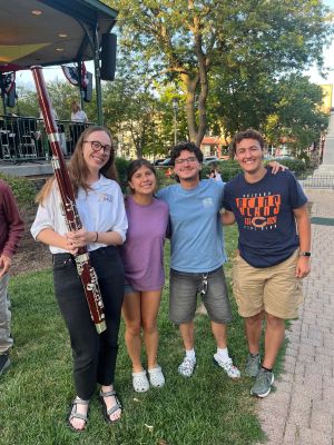A group of four young people, one holding a clarinet